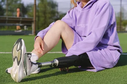 Usuario con prótesis de miembro inferior en campo deportivo — Adaptación protésica orientada a la movilidad activa y la comodidad diaria